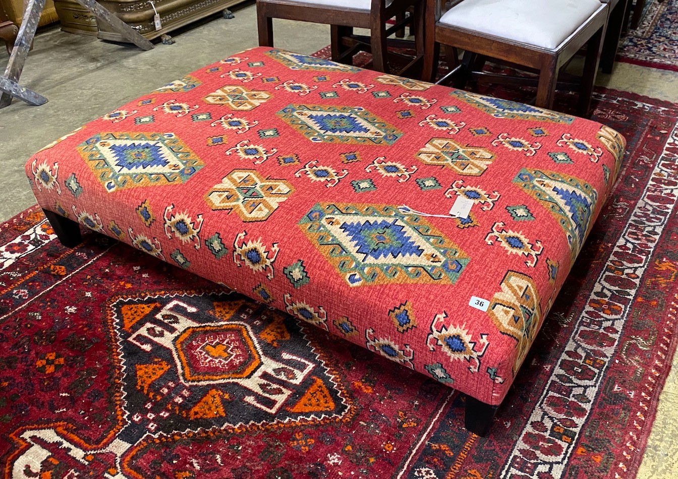 A large rectangular contemporary footstool upholstered in Kilim style fabric, length 122cm, depth 90cm, height 28cm